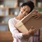 a woman hugging a courier services box