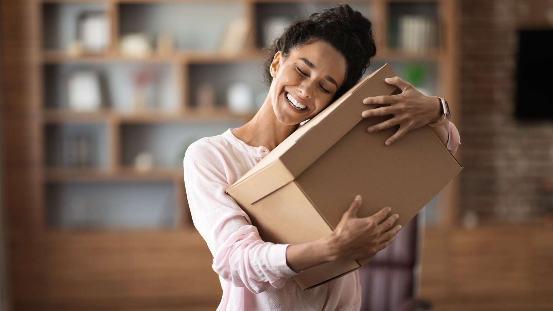 a woman hugging a courier services box