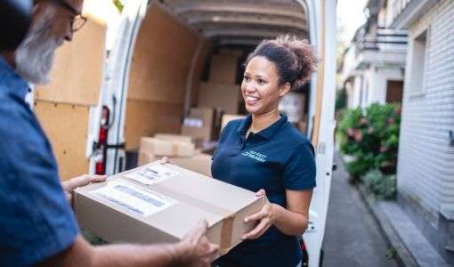 a woman receiving a package from a delivery man